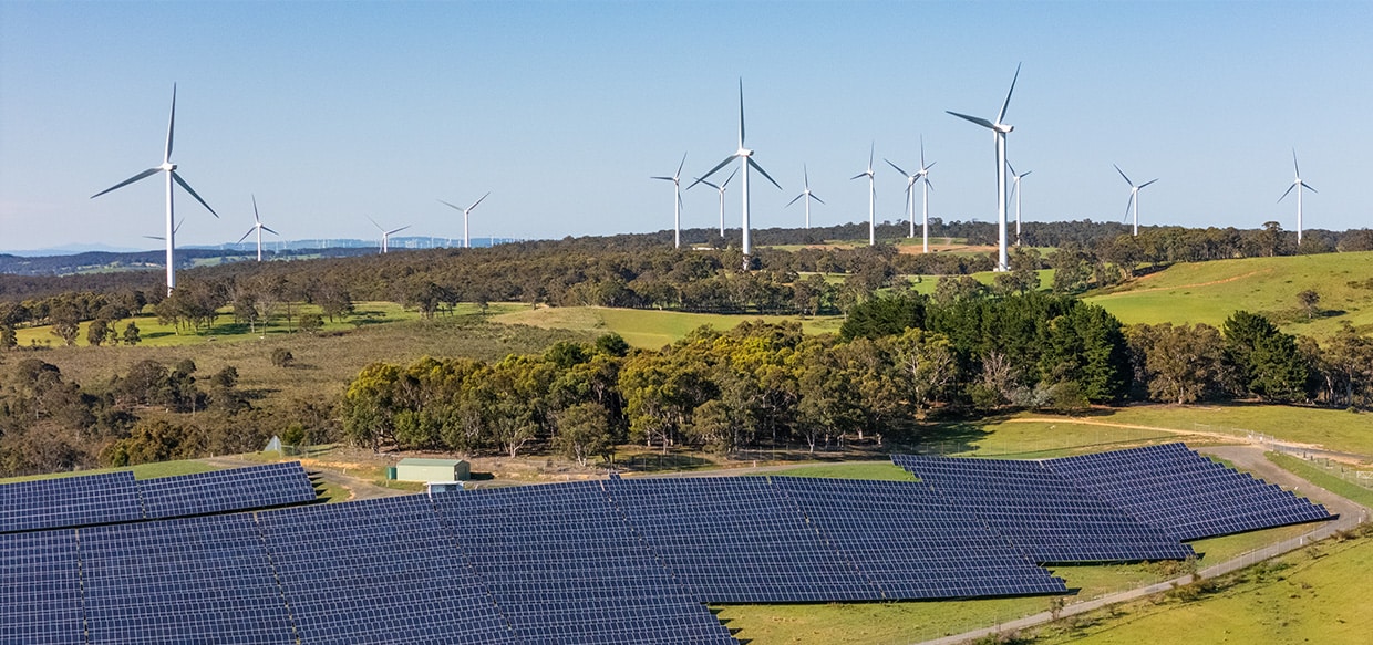 Wind turbines and solar panels in a rural setting 